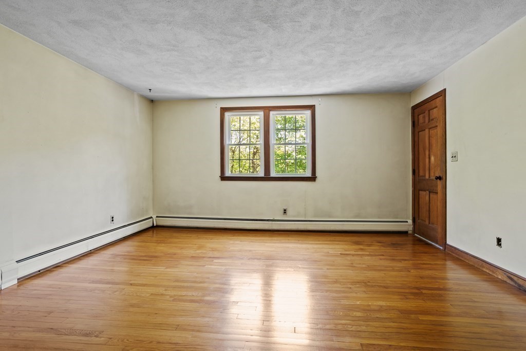 34 Duggan Road Acton, MA 01720 - Photo 26 of 42 a view of an empty room with wooden floor and a window