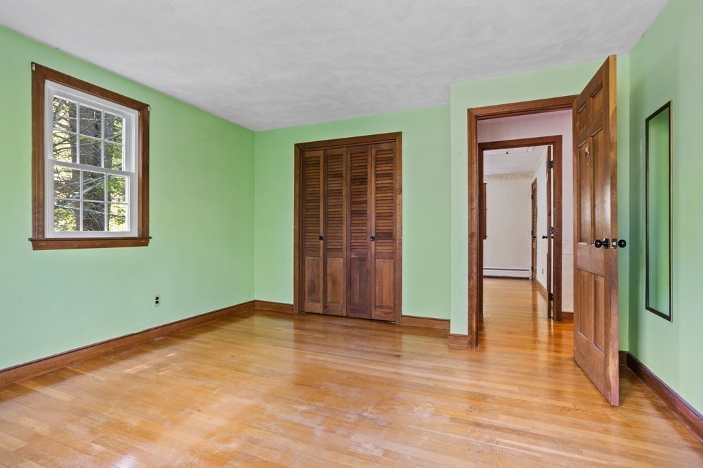 34 Duggan Road Acton, MA 01720 - Photo 29 of 42 a view of empty room with wooden floor and fan