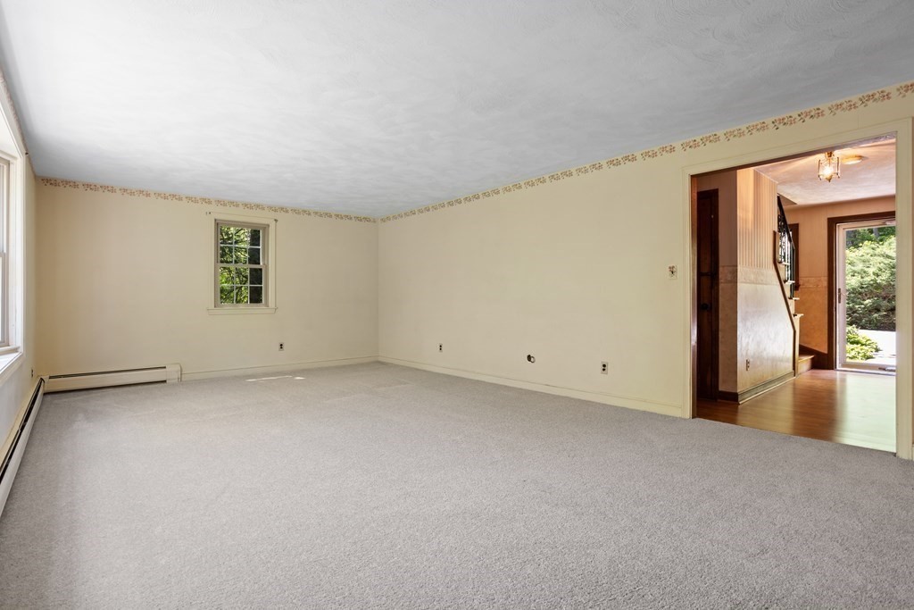 34 Duggan Road Acton, MA 01720 - Photo 3 of 42 a view of a big room with windows and chandelier fan