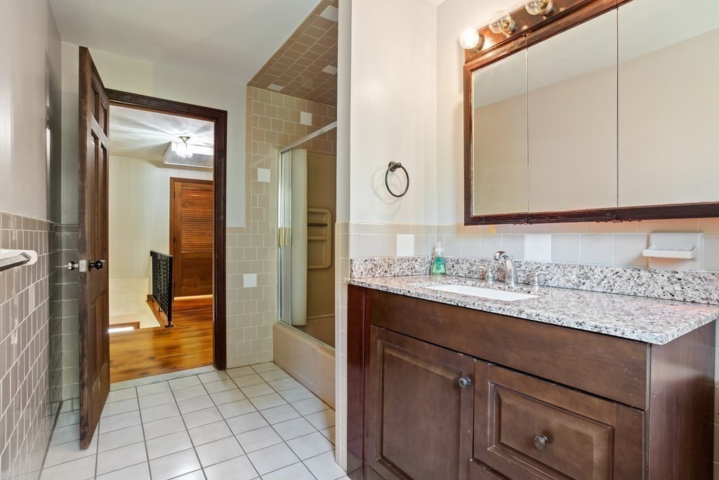 34 Duggan Road Acton, MA 01720 - Photo 32 of 42 a bathroom with a granite countertop sink and a mirror