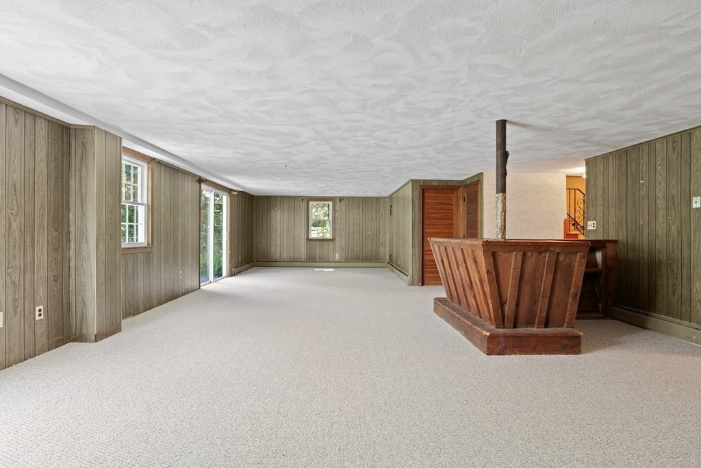 34 Duggan Road Acton, MA 01720 - Photo 34 of 42 a view of an empty room with wooden floor and windows