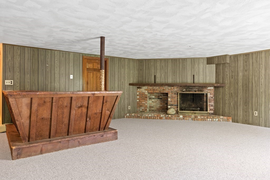 34 Duggan Road Acton, MA 01720 - Photo 35 of 42 an entryway with fireplace and windows