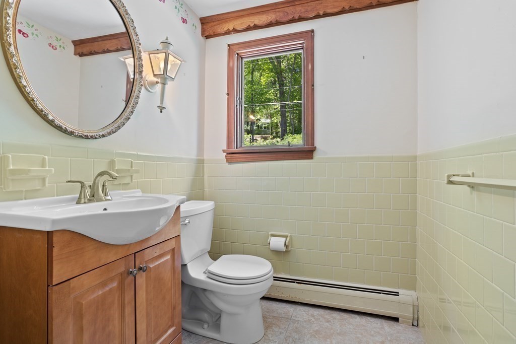 34 Duggan Road Acton, MA 01720 - Photo 9 of 42 a bathroom with a toilet a sink a mirror and window