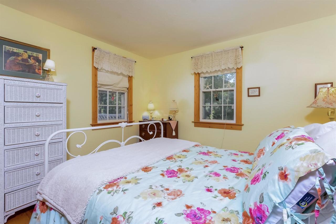 71 Wakeby Road Marstons Mills, MA 02648 - Photo 16 of 31 a bedroom with a bed a dresser and next to a window