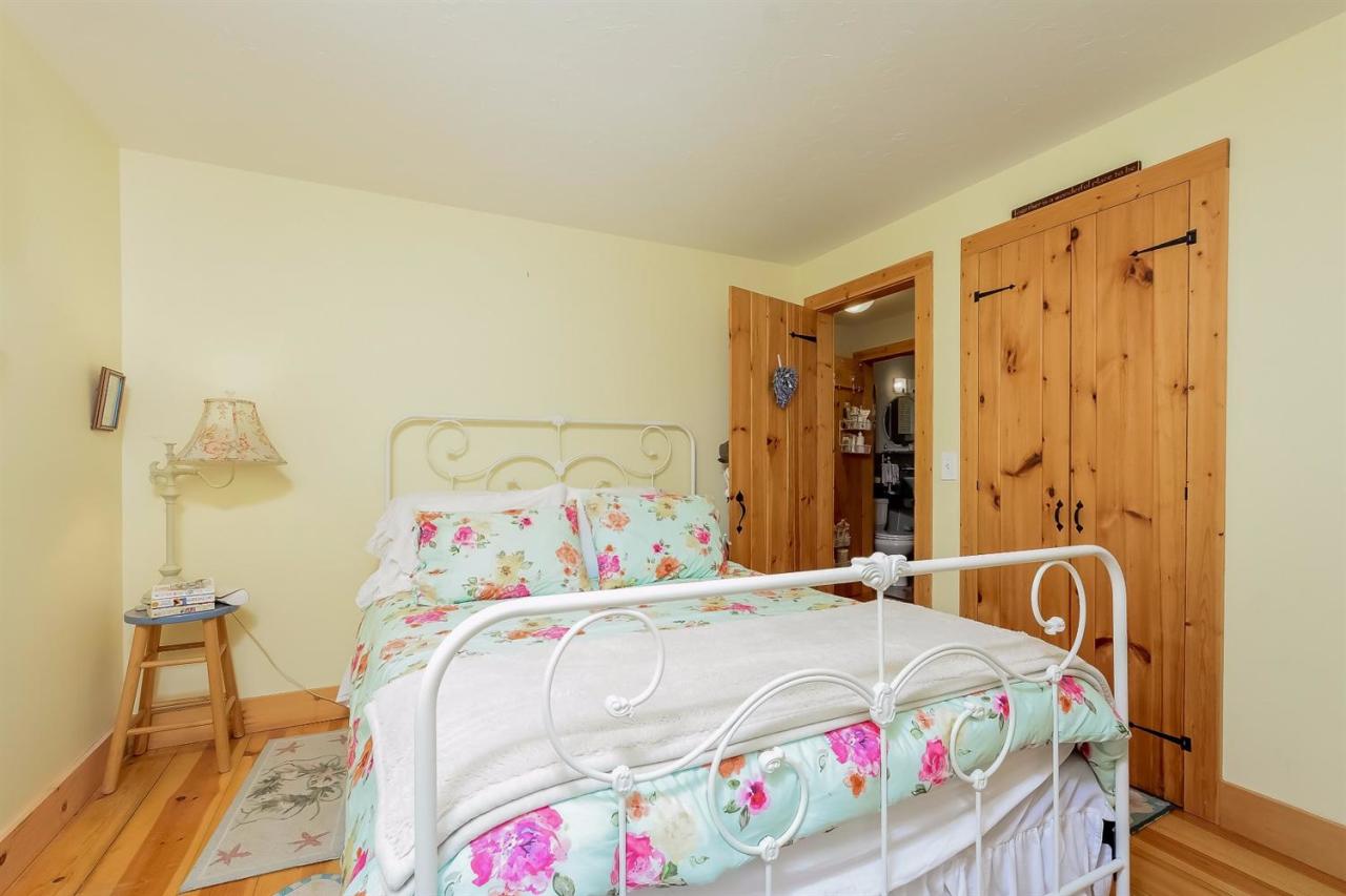 71 Wakeby Road Marstons Mills, MA 02648 - Photo 17 of 31 a bedroom with a bed and a table