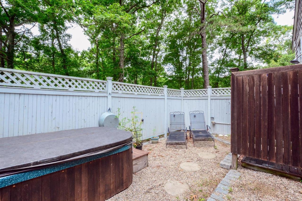 71 Wakeby Road Marstons Mills, MA 02648 - Photo 23 of 31 a backyard of a house with chairs and a table