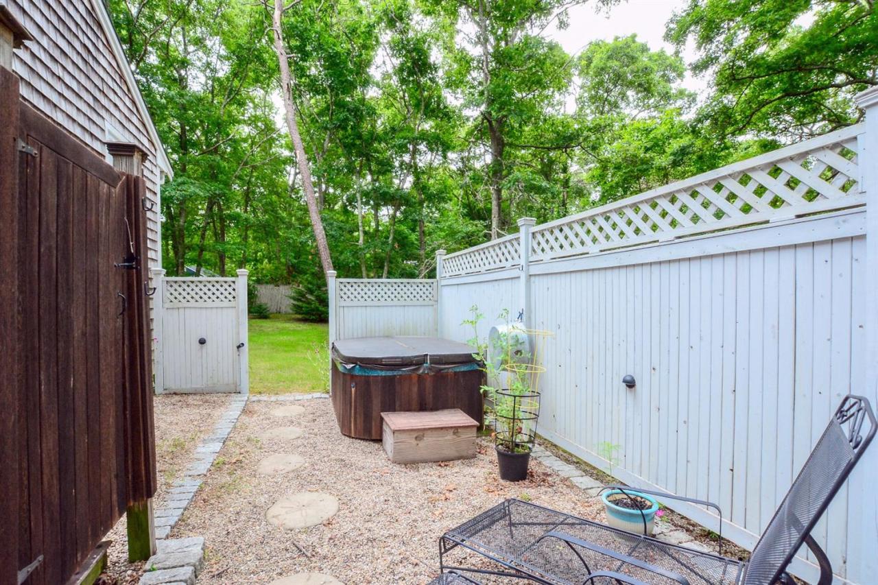 71 Wakeby Road Marstons Mills, MA 02648 - Photo 25 of 31 a backyard of a house with chairs and wooden fence