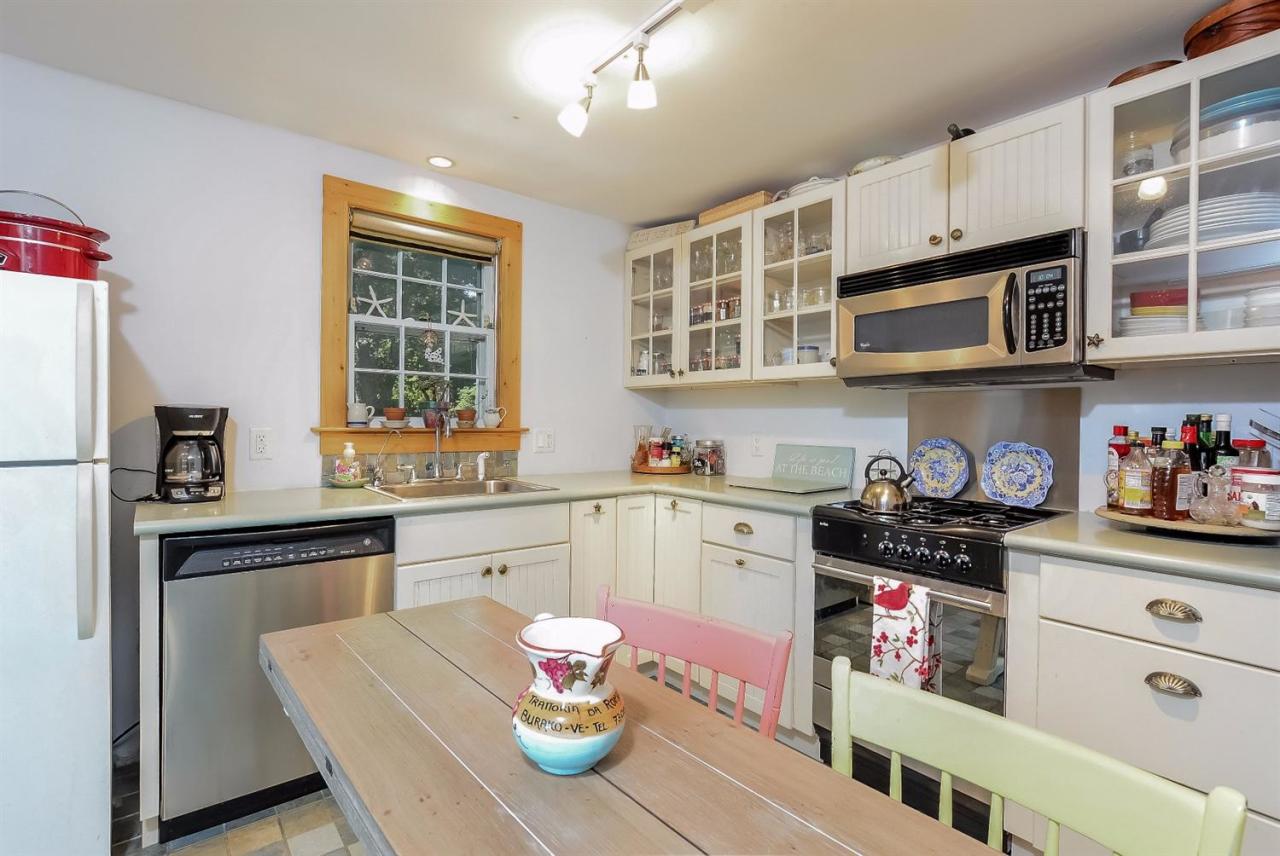 71 Wakeby Road Marstons Mills, MA 02648 - Photo 7 of 31 a kitchen with stainless steel appliances granite countertop a stove a sink dishwasher and cabinets with wooden floor