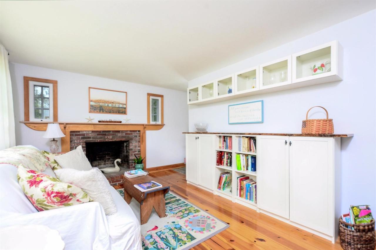 71 Wakeby Road Marstons Mills, MA 02648 - Photo 10 of 31 a living room with baby crib and a fireplace