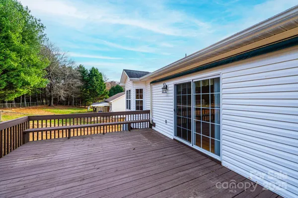 a view of a roof deck with wooden floor and fence