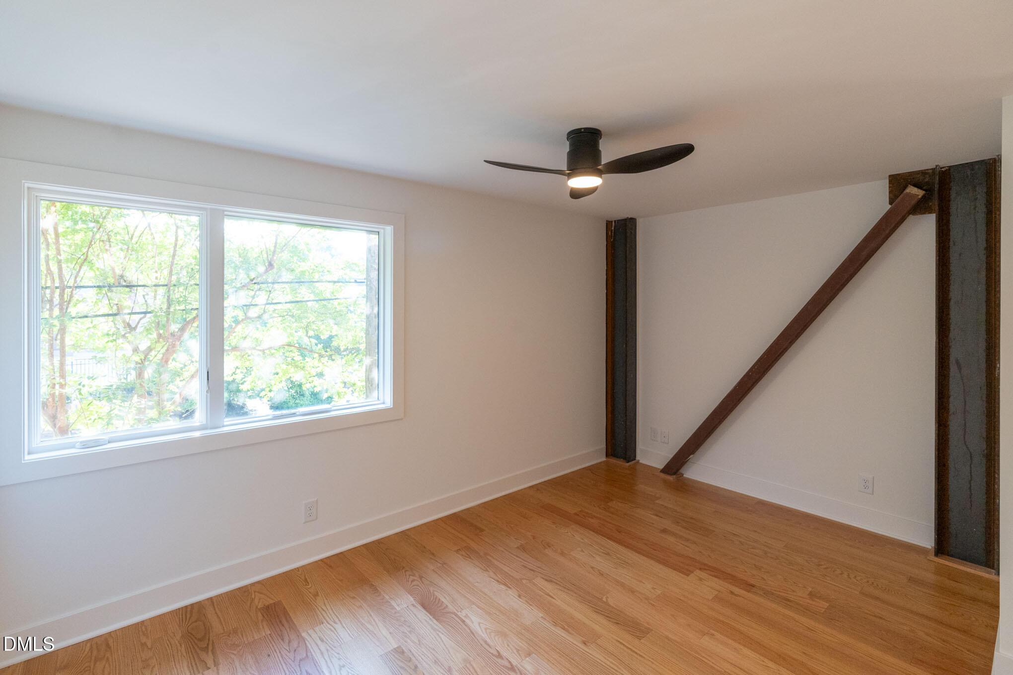 402 East Martin Street Raleigh, NC 27601 - Photo 12 of 23 a view of empty room with wooden floor and fan