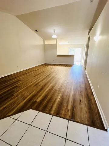 a view of a room with wooden floor