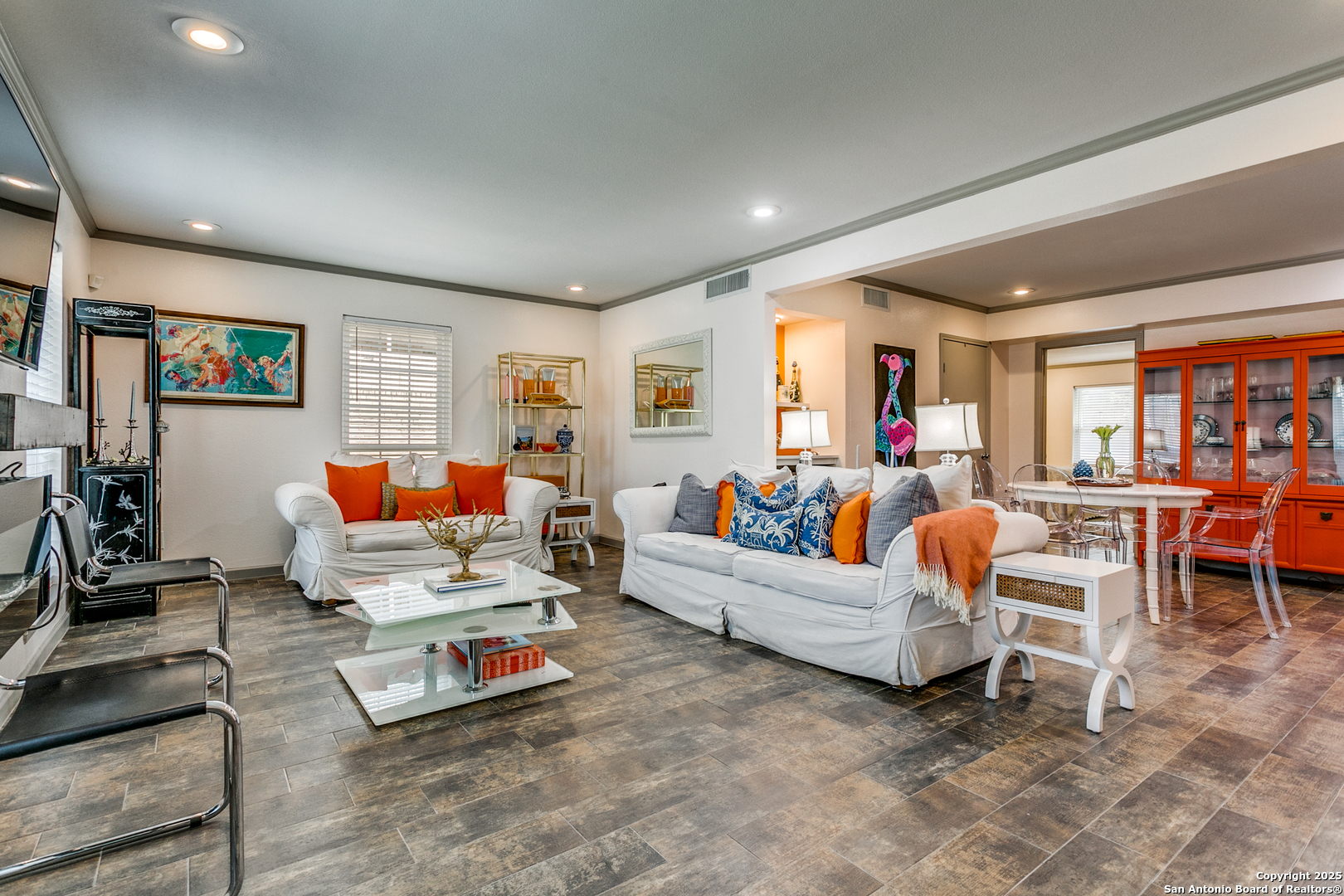 a living room with furniture a flat screen tv and a table