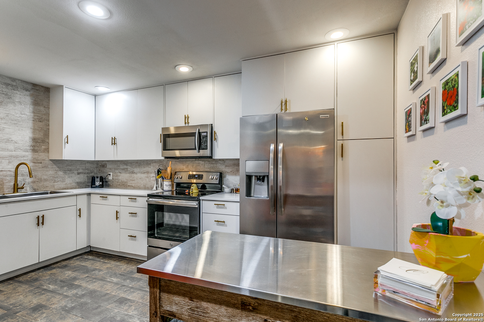 109 Ruelle Lane, Unit 109A San Antonio, TX 78209 - Photo 11 of 23 a kitchen with stainless steel appliances granite countertop a refrigerator and a stove