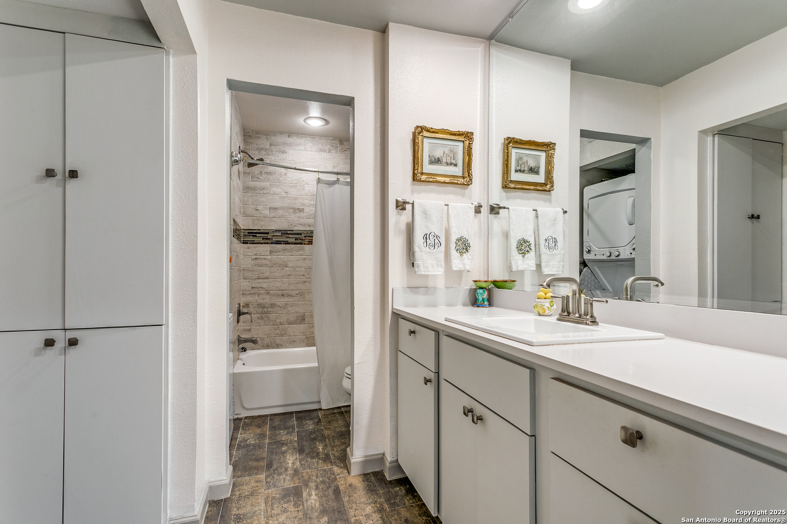 109 Ruelle Lane, Unit 109A San Antonio, TX 78209 - Photo 18 of 23 a bathroom with a shower sink and mirror