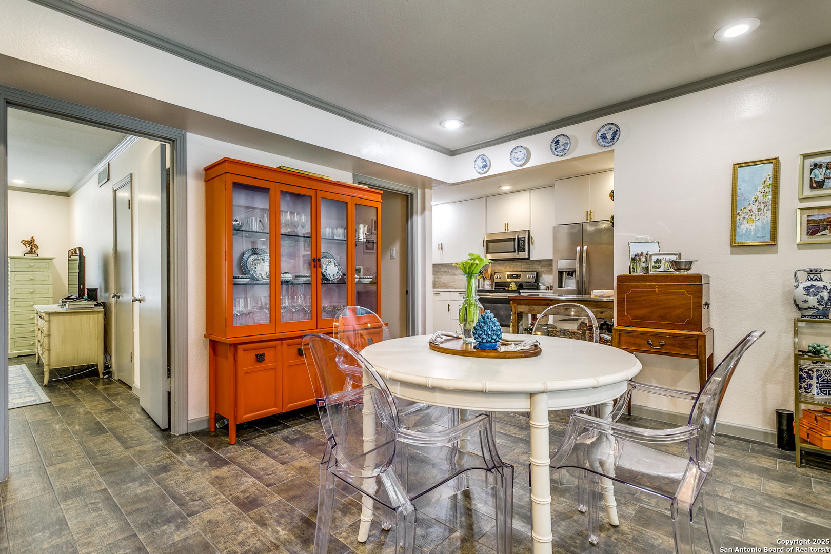 109 Ruelle Lane, Unit 109A San Antonio, TX 78209 - Photo 10 of 23 a kitchen with stainless steel appliances kitchen island granite countertop a table and chairs in it