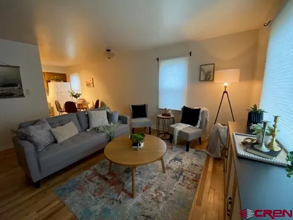 a living room with furniture and a lamp