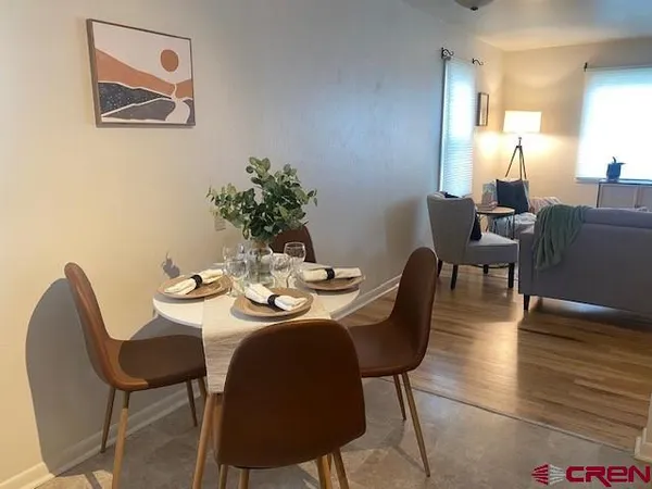 a view of a dining room with furniture and wooden floor