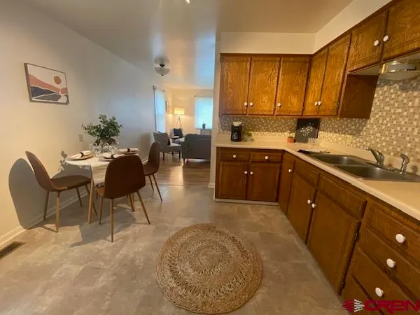 a kitchen with stainless steel appliances granite countertop sink stove and cabinets
