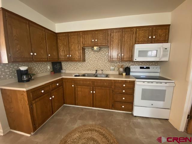 243 North Madison Street Cortez, CO 81321 - Photo 16 of 29 a kitchen with a sink a stove and cabinets