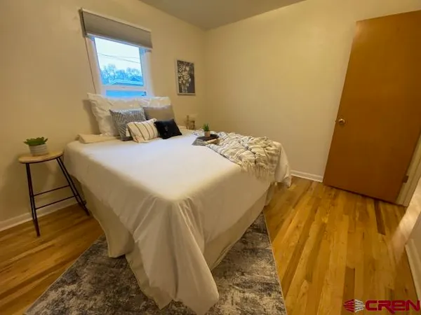 a bed sitting in a bedroom next to a blue wall