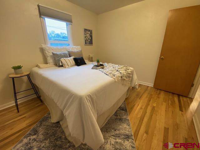 243 North Madison Street Cortez, CO 81321 - Photo 19 of 29 a bed sitting in a bedroom next to a blue wall