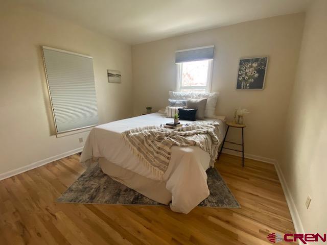 243 North Madison Street Cortez, CO 81321 - Photo 20 of 29 a bed sitting in a bedroom next to a window