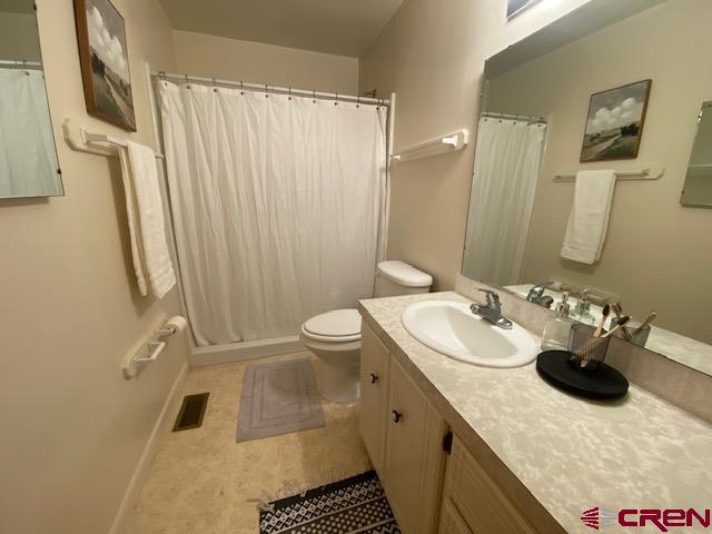 243 North Madison Street Cortez, CO 81321 - Photo 21 of 29 a bathroom with a sink toilet and shower