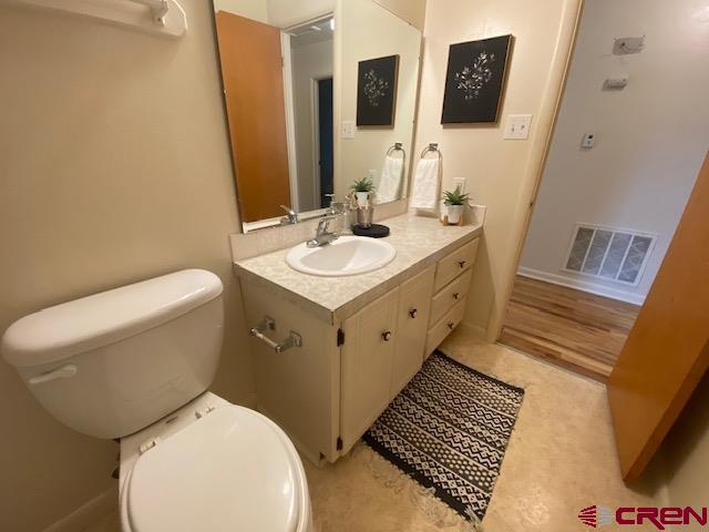 243 North Madison Street Cortez, CO 81321 - Photo 22 of 29 a bathroom with a toilet sink and mirror