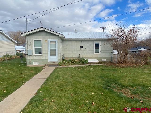 243 North Madison Street Cortez, CO 81321 - Photo 25 of 29 a front view of house with yard and green space