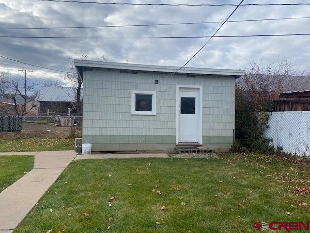 243 North Madison Street Cortez, CO 81321 - Photo 26 of 29 a brick house with a yard