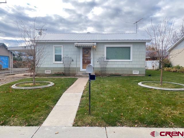 243 North Madison Street Cortez, CO 81321 - Photo 29 of 29 a view of a house with a backyard and a fountain
