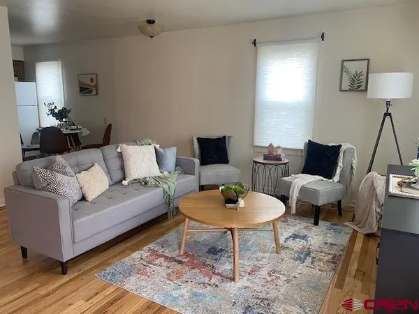 a living room with furniture and a lamp