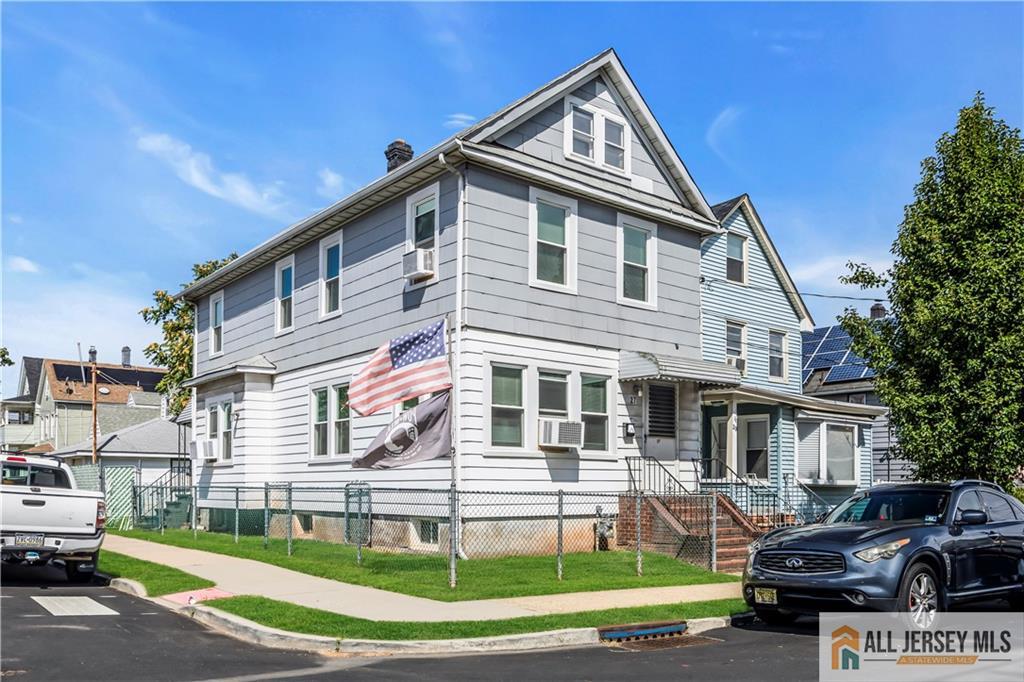 27 Charles Street Carteret, NJ 07008 - Photo 1 of 40 a front view of a house with a yard