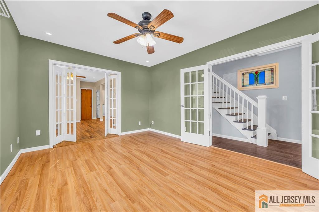 27 Charles Street Carteret, NJ 07008 - Photo 11 of 40 a bedroom with a large bed and a chandelier