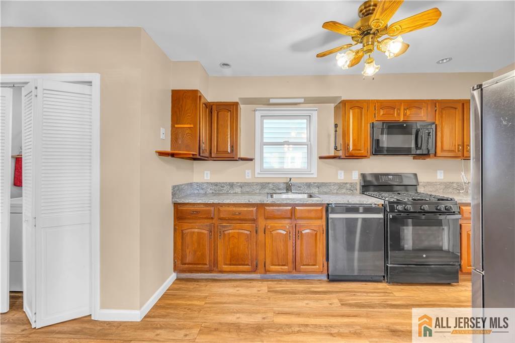 27 Charles Street Carteret, NJ 07008 - Photo 15 of 40 a kitchen with stainless steel appliances granite countertop a stove and a sink