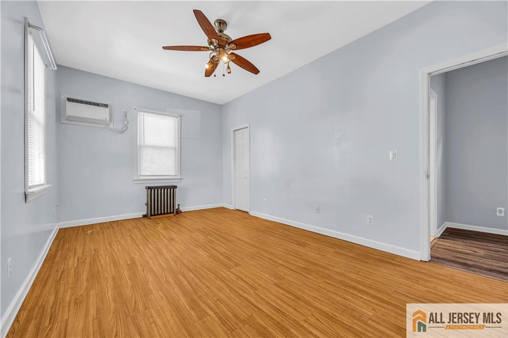 27 Charles Street Carteret, NJ 07008 - Photo 24 of 40 a view of empty room with wooden floor and fan