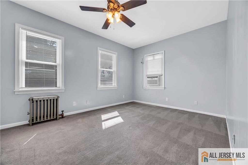 27 Charles Street Carteret, NJ 07008 - Photo 26 of 40 an empty room with windows and fan