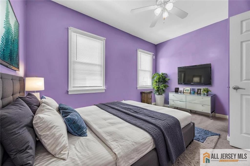 27 Charles Street Carteret, NJ 07008 - Photo 27 of 40 a bedroom with a bed and a flat screen tv