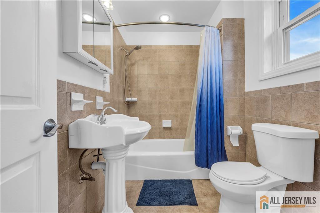 27 Charles Street Carteret, NJ 07008 - Photo 29 of 40 a bathroom with a sink toilet and shower