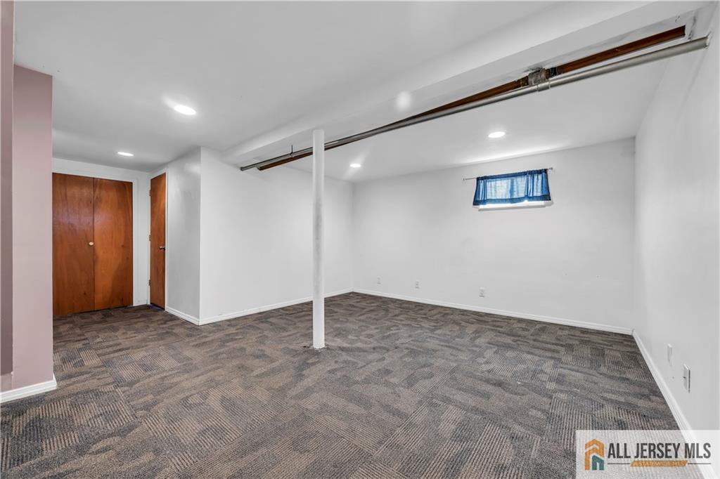 27 Charles Street Carteret, NJ 07008 - Photo 33 of 40 an empty room with a ceiling fan and closet