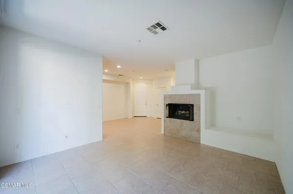 a view of an empty room with a fireplace