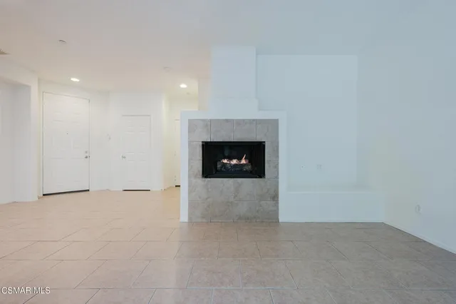 a view of an empty room with a fireplace