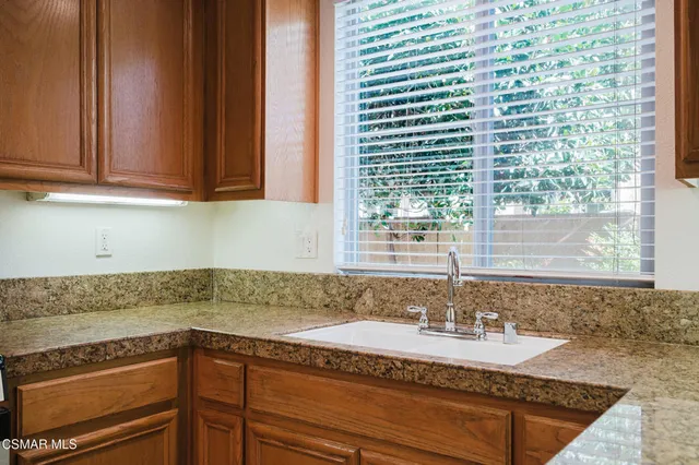 a kitchen with granite countertop a sink and a granite counter tops