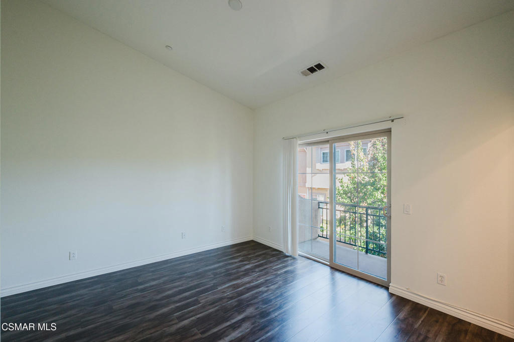 1454 Patricia Avenue, Unit 402 Simi Valley, CA 93065 - Photo 26 of 50 a view of an empty room with wooden floor and a window