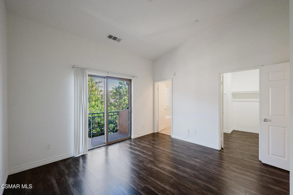 1454 Patricia Avenue, Unit 402 Simi Valley, CA 93065 - Photo 28 of 50 a view of an empty room with wooden floor and a window
