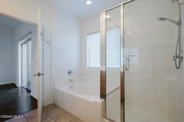 a bathroom with a bathtub and a shower