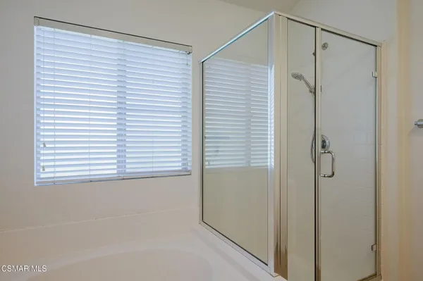 a bathroom with a shower and a window