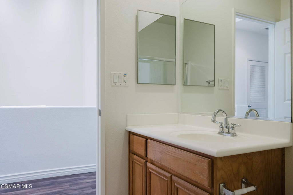 1454 Patricia Avenue, Unit 402 Simi Valley, CA 93065 - Photo 35 of 50 a bathroom with a sink and a mirror