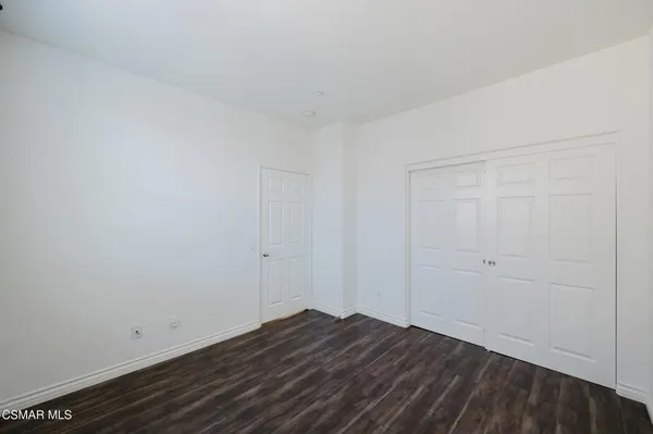 a view of room with wooden floor